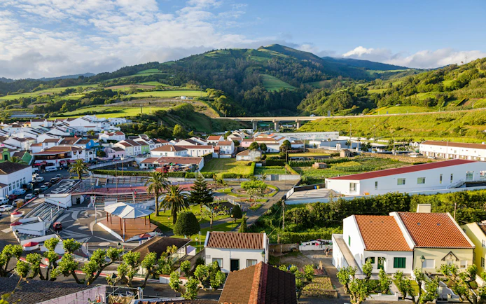 Aerial view of Agua De Pau village with lush green hills in Sao Miguel Island, Azores.