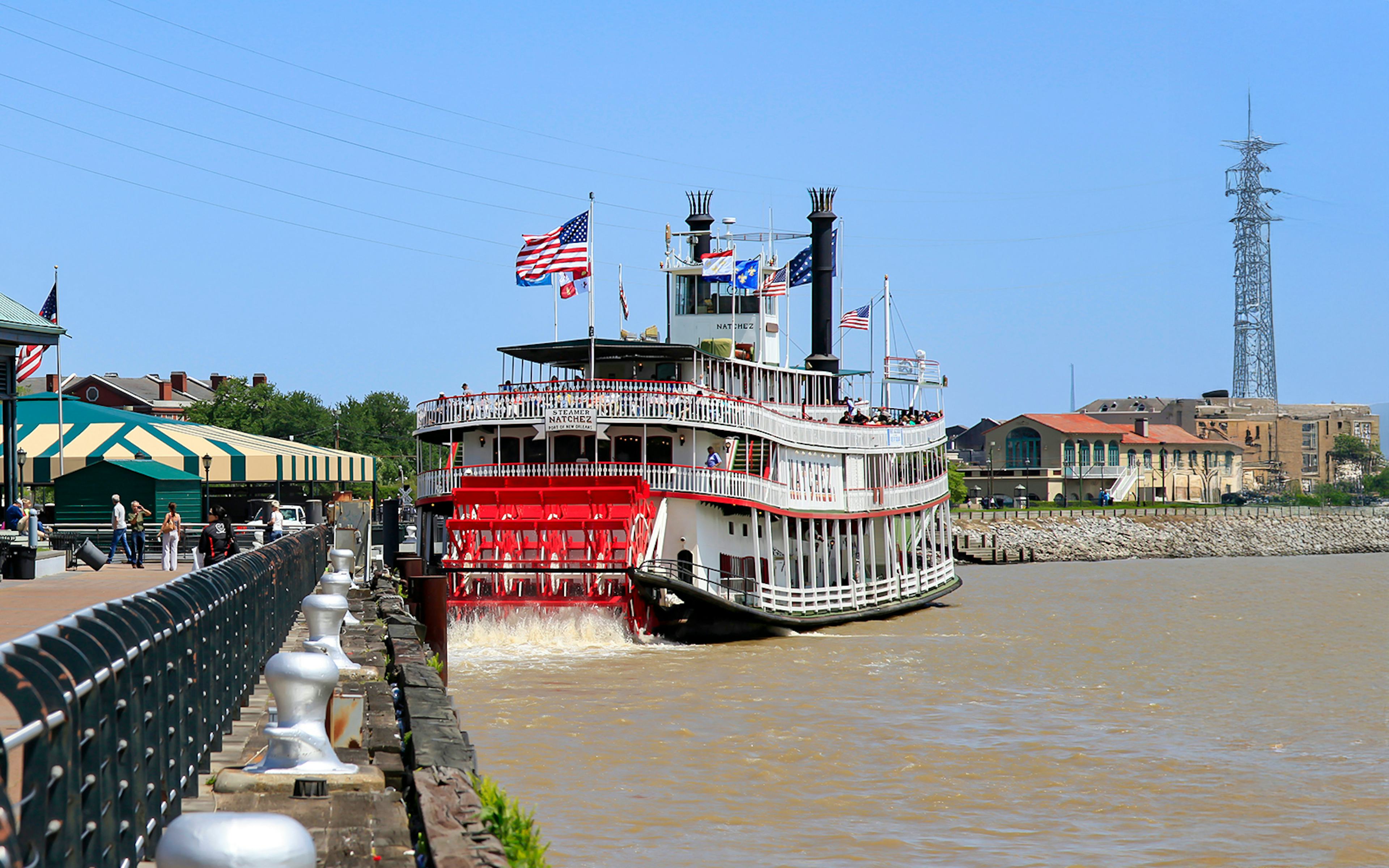 People walking upto Steamboat Natchez docked in the French Quarter, New Orleans