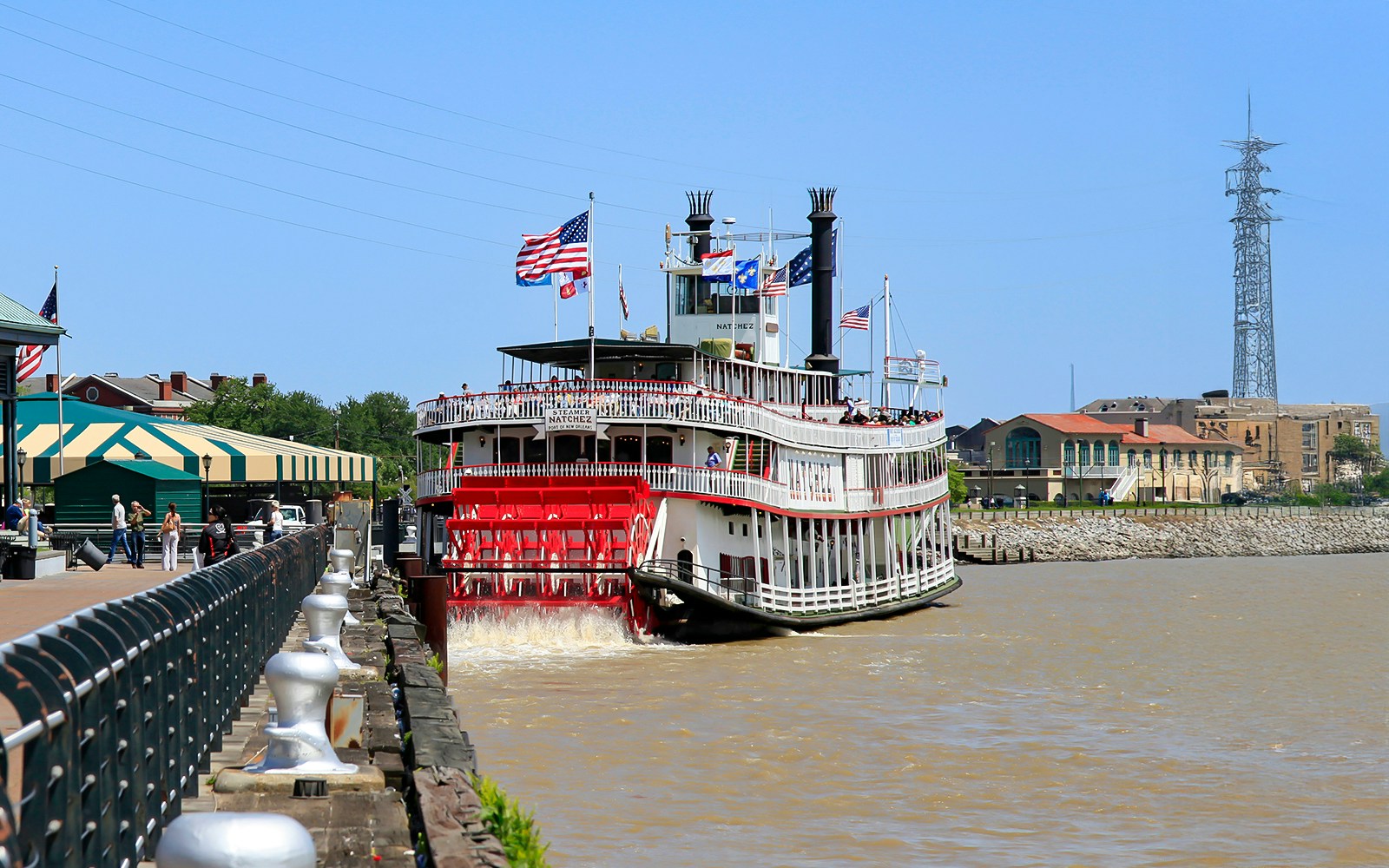 People walking upto Steamboat Natchez docked in the French Quarter, New Orleans