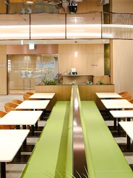 Wooden chairs and tables at Plaza Premium Lounge, South Korea.