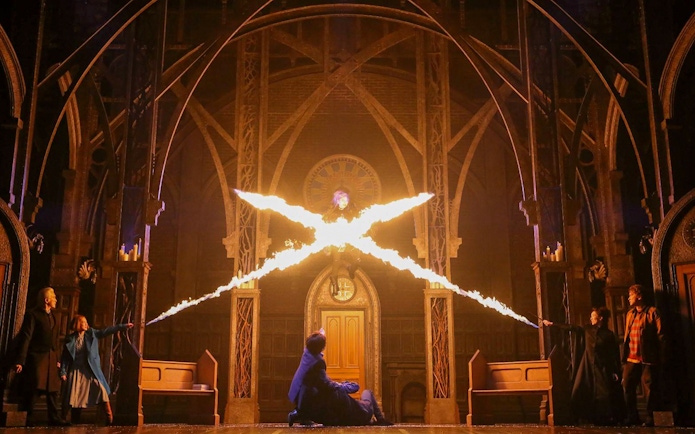 Characters casting spells in a dramatic scene from "Harry Potter and the Cursed Child" play.