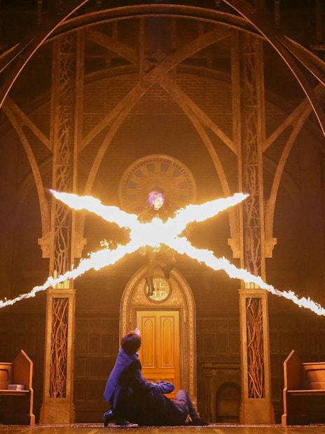 Characters casting spells in a dramatic scene from "Harry Potter and the Cursed Child" play.