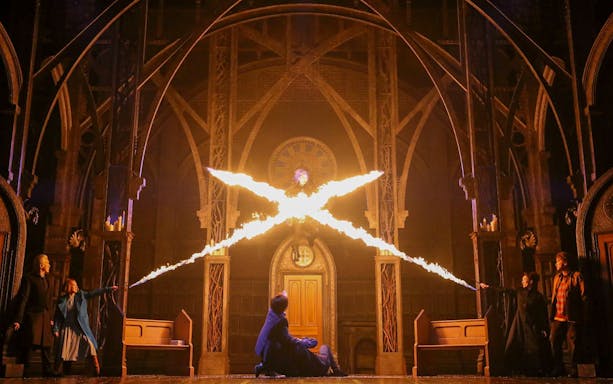Characters casting spells in a dramatic scene from "Harry Potter and the Cursed Child" play.