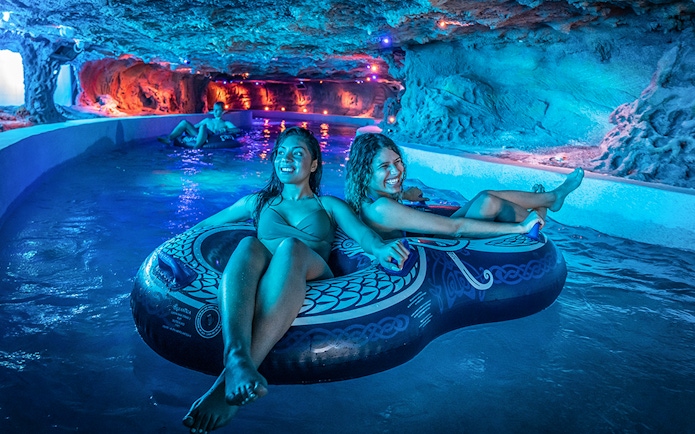 Visitors enjoying a lazy river ride at Rulantica water park.