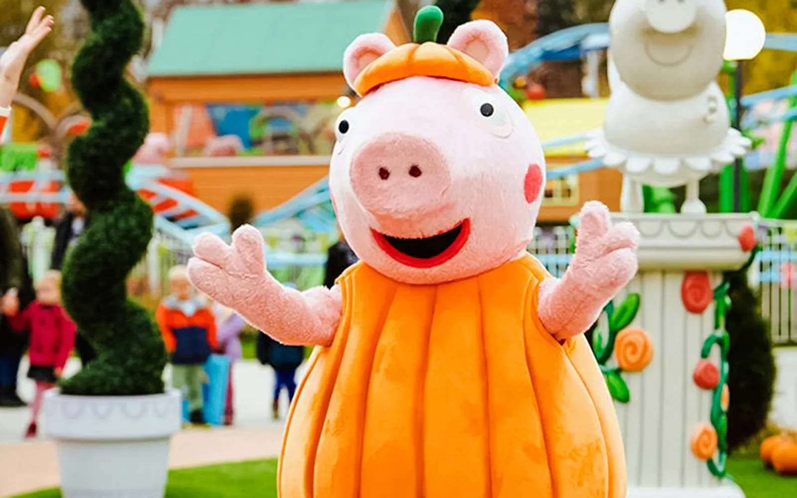 Peppa Pig in a pumpkin costume at Halloween event in Peppa Pig Park.