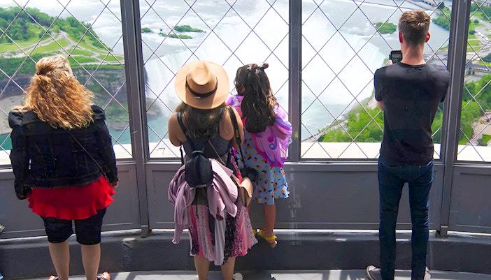 Visitors at Skylon Tower observation deck overlooking Niagara Falls, Canada.
