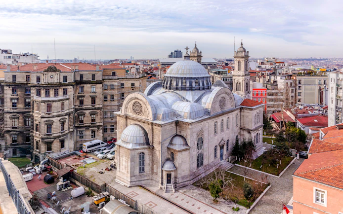 Hagia Triada Church with domes and surrounding buildings in Istanbul, Turkey.