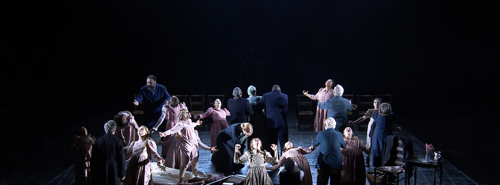 Stage performance of "The Crucible" with actors in period costumes, dramatic scene.