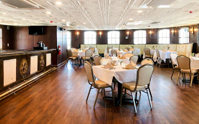 Elegant dining area set for brunch on the Riverboat City of New Orleans cruise.