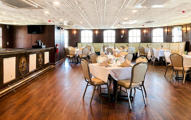 Elegant dining area set for brunch on the Riverboat City of New Orleans cruise.