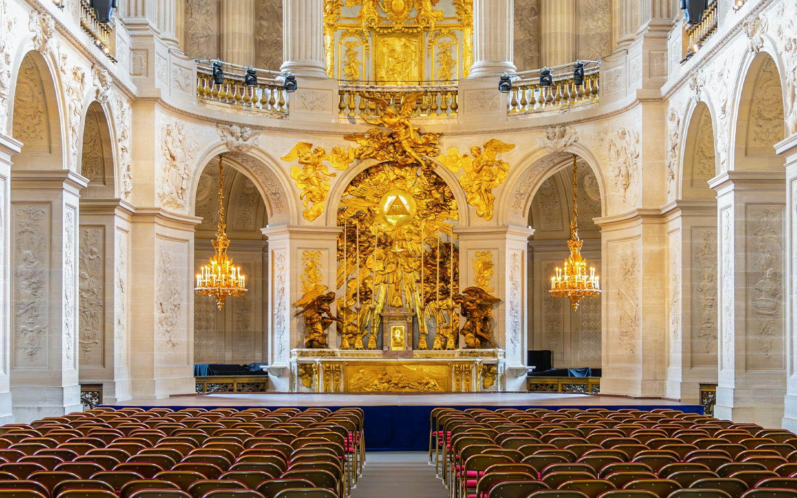 Royal Chapel of Versailles altar with ornate carvings and golden accents, France.