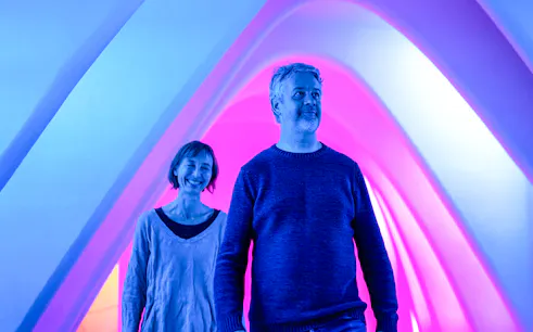 Visitors enjoying Casa Batlló's illuminated arches during a winter night tour.