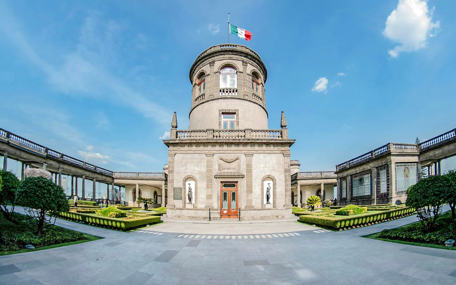 Chapultepec Castle exterior with central tower and Mexican flag in Mexico City.