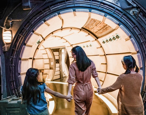 Guests entering Star Wars-themed tunnel at Disneyland Adventure Park, California.