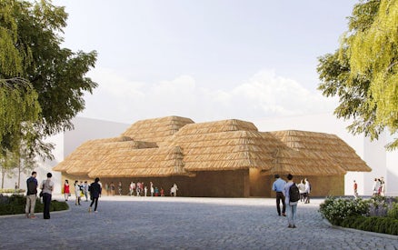 Earth Mart Pavilion with thatched roof at Expo 2025 Osaka, Kansai, surrounded by visitors.