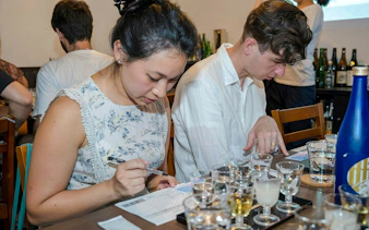 Couple reviewing menu at Kyoto sake tasting experience.