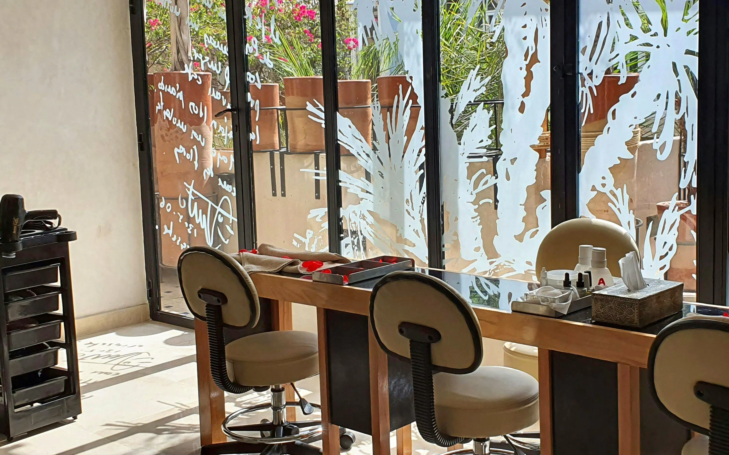 Nail salon area at Le Bain Bleu Hammam & Spa, Marrakesh with chairs and manicure tools.