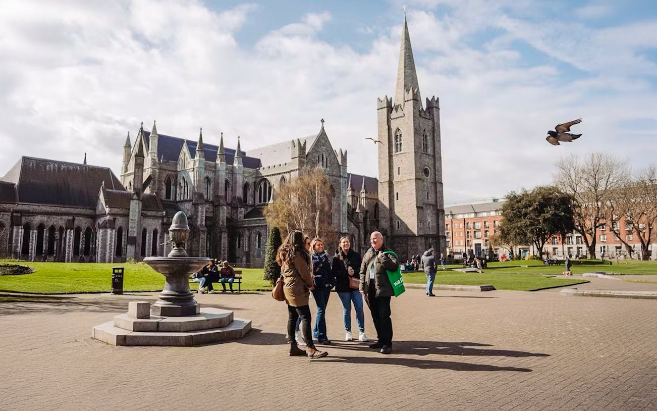 Group of tourists at St. Patrick's Cathedral, Dublin, during a city tour.