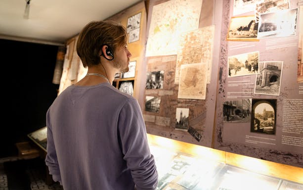 Man viewing Krakow photos at Oskar Schindler's Factory exhibit.