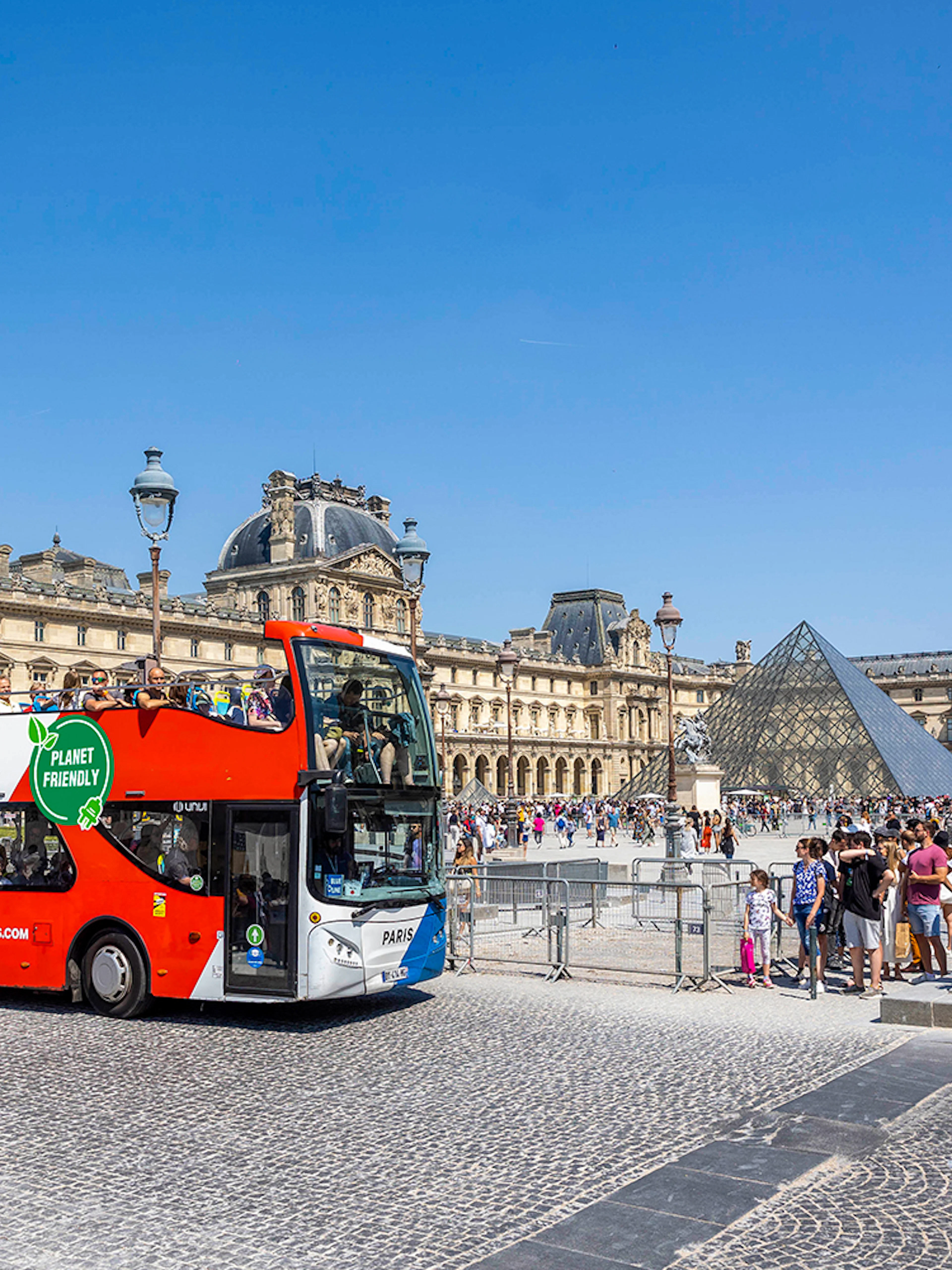 Tootbus double-decker bus in front of the Louvre Museum, Paris.
