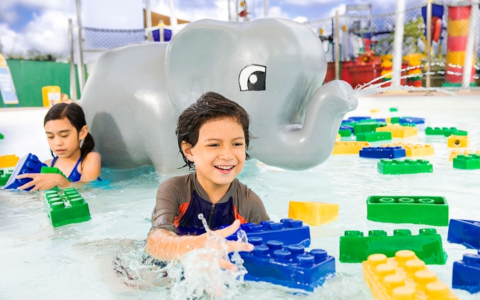 Children playing with LEGO bricks in water at LEGOLAND Malaysia Water Park.