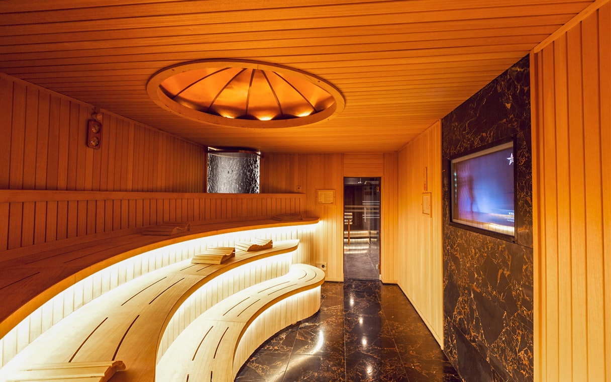 Istanbul Turkish bath entrance with wooden benches and marble floor.