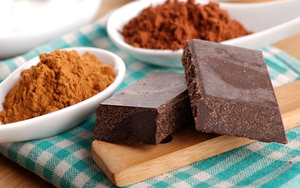 Chocolate bars and cocoa powder for tasting in Modica trattoria.
