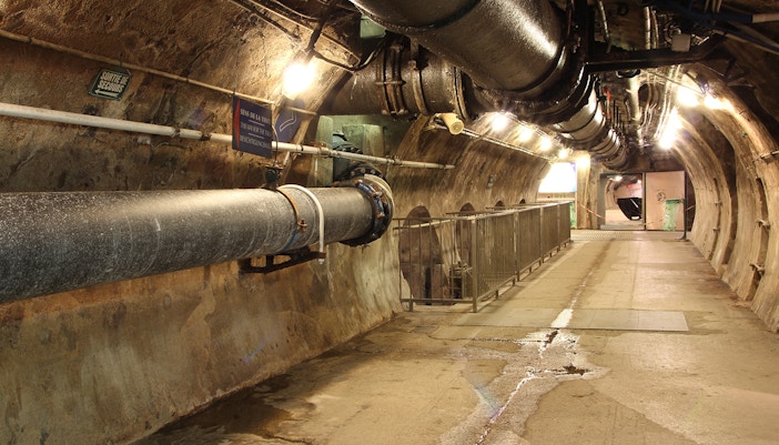 Underground passage with pipes at Paris Sewer Museum.