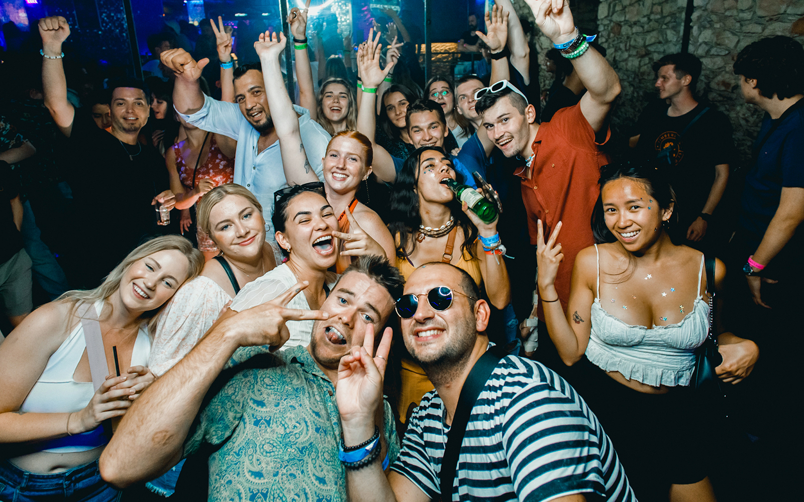 Group enjoying a lively boat party in Prague with drinks and dancing.
