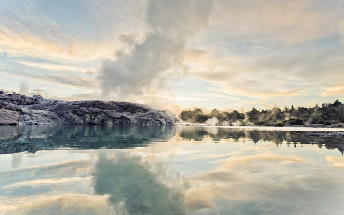 Geothermal steam rising from Te Puia's Pohutu Geyser in Rotorua, New Zealand.