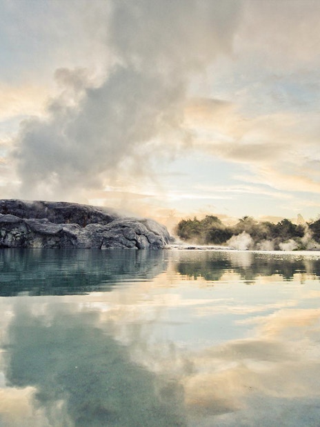 Geothermal steam rising from Te Puia's Pohutu Geyser in Rotorua, New Zealand.