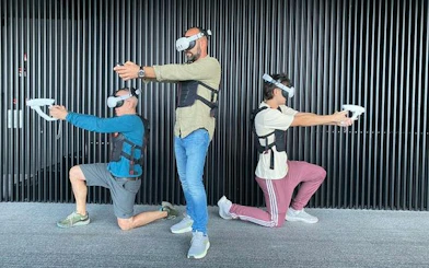 Three people wearing VR headsets and vests, engaging in a virtual reality experience at Lotte Hanoi Sky Chill 3, Dubai.