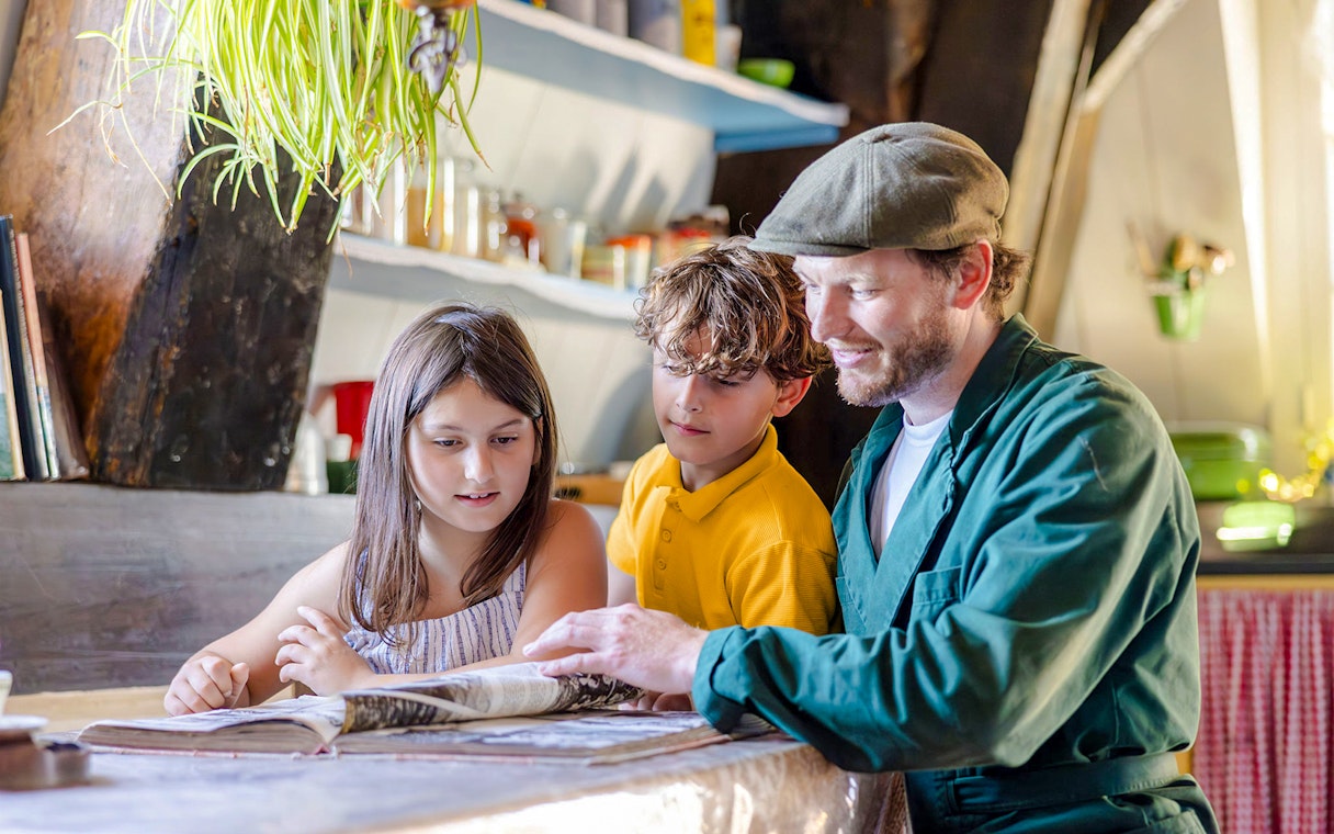 Father and children reading inside Nederwaard Museum Mill at Kinderdijk.