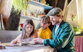Father and children reading inside Nederwaard Museum Mill at Kinderdijk.