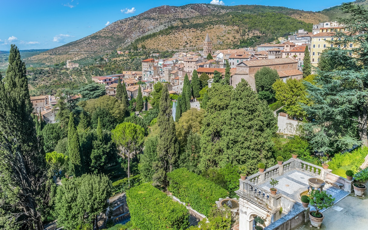 Villa d'Este gardens in Tivoli, Italy, featuring lush greenery and historic architecture.