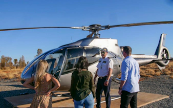 Tourists preparing for Uluru and Kata Tjuta helicopter experience in Australia.