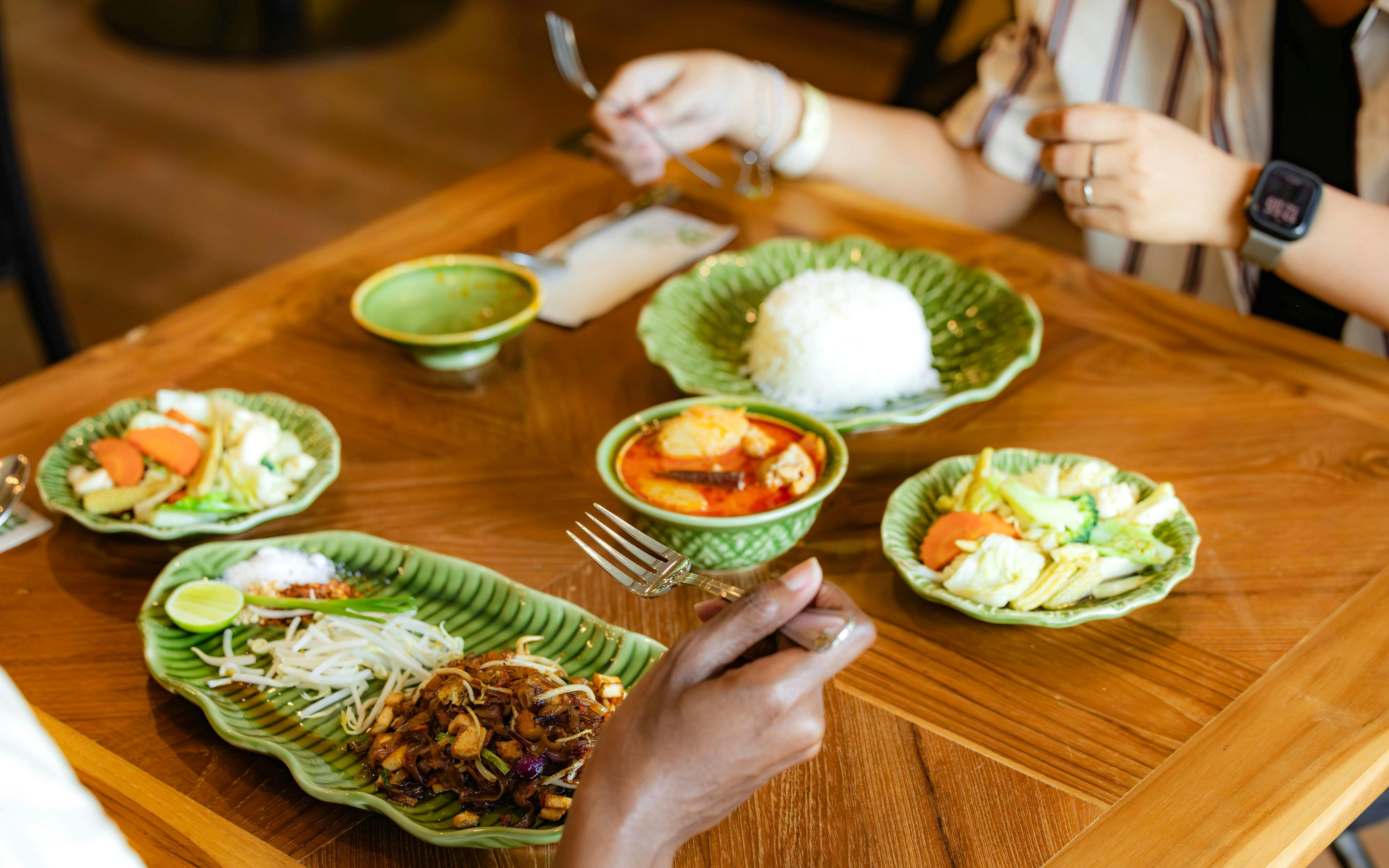 Thai meal with curry, rice, and vegetables at SKY ROCK Thailand eco-friendly adventure.