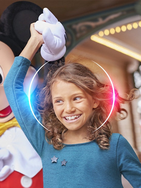 Child enjoying Disneyland Paris with a character.