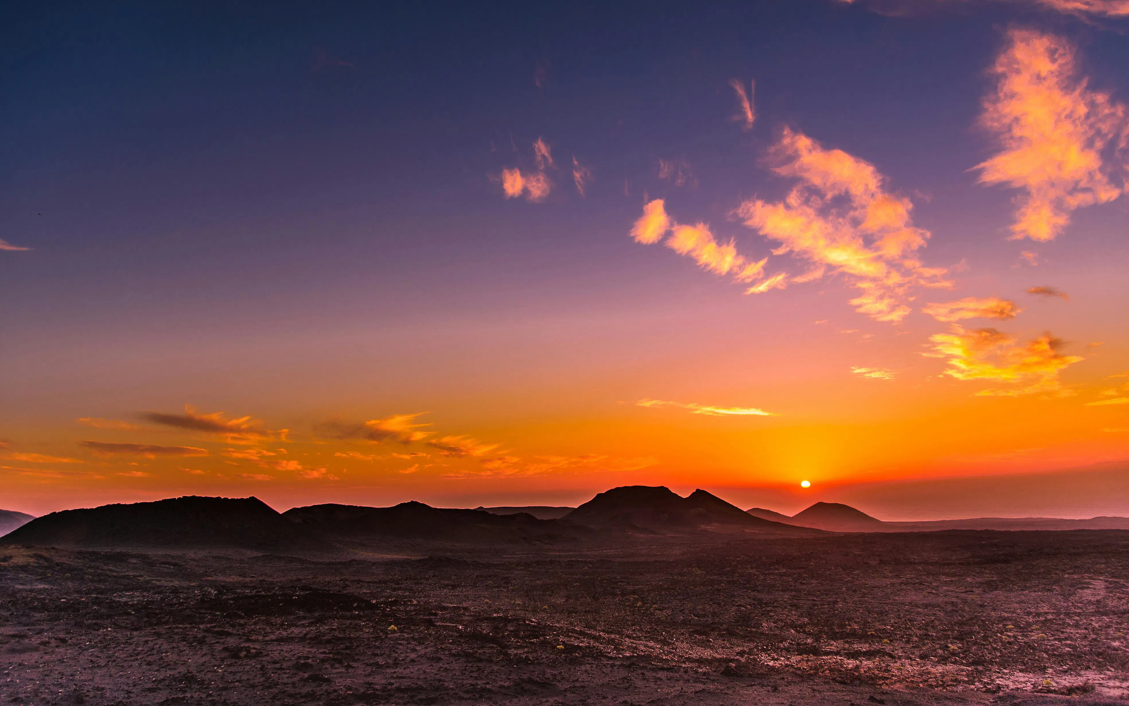 Sunset over volcanic landscape at Timanfaya National Park, Lanzarote.