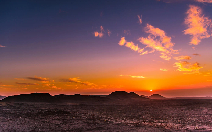 Sunset over volcanic landscape at Timanfaya National Park, Lanzarote.