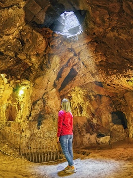 Person exploring Derinkuyu underground city in Cappadocia, Turkey.