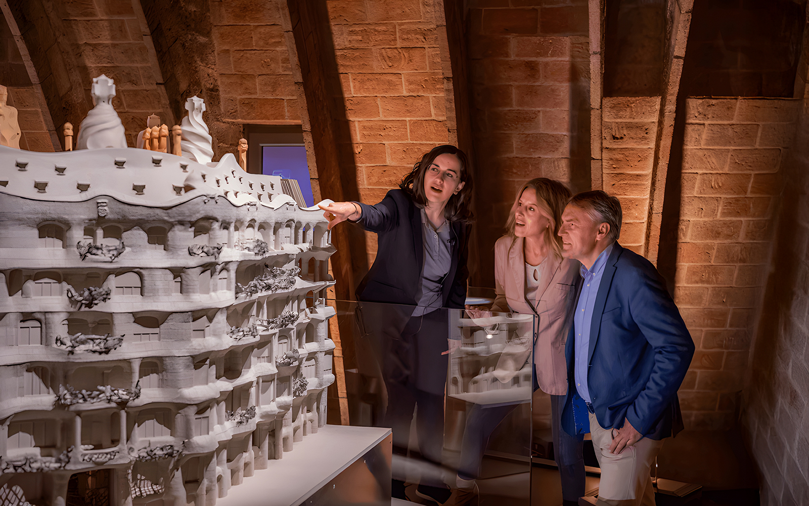 Visitors examining a model of La Pedrera in The Whale Attic, Barcelona.
