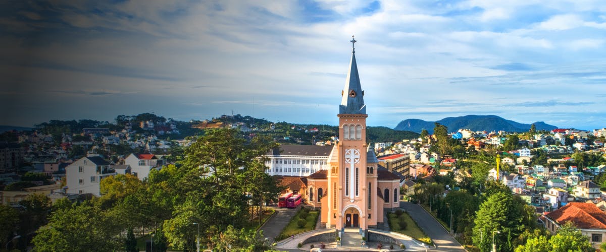 Dalat Cathedral with cityscape and hills in Dalat, Vietnam.