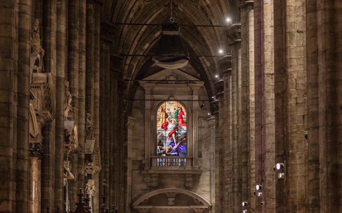 Stained glass window inside Milan Duomo Cathedral, Italy.