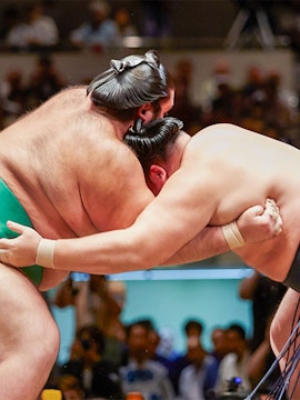 Sumo wrestlers competing in a tournament in Osaka arena.