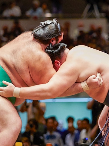 Sumo wrestlers competing in a tournament in Osaka arena.
