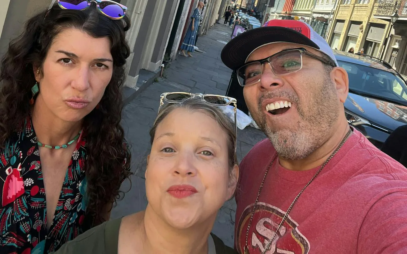 Group enjoying a self-guided city exploration game on a street in New Orleans.