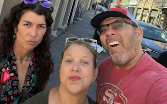 Group enjoying a self-guided city exploration game on a street in New Orleans.
