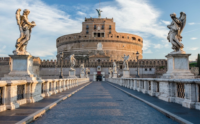Tourists on Ponte Sant'Angelo with Castel Sant'Angelo in Rome, Italy.