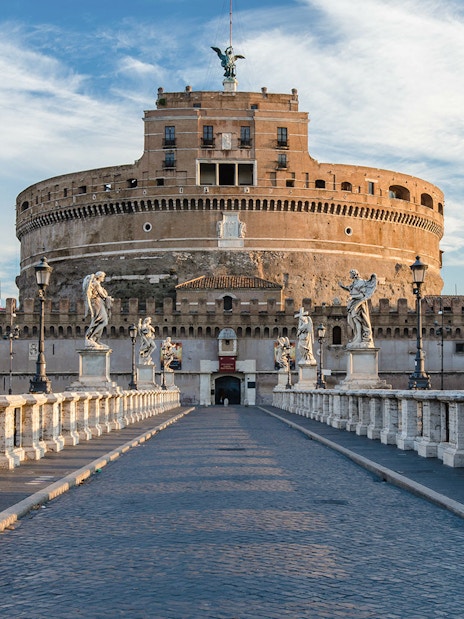 Tourists on Ponte Sant'Angelo with Castel Sant'Angelo in Rome, Italy.